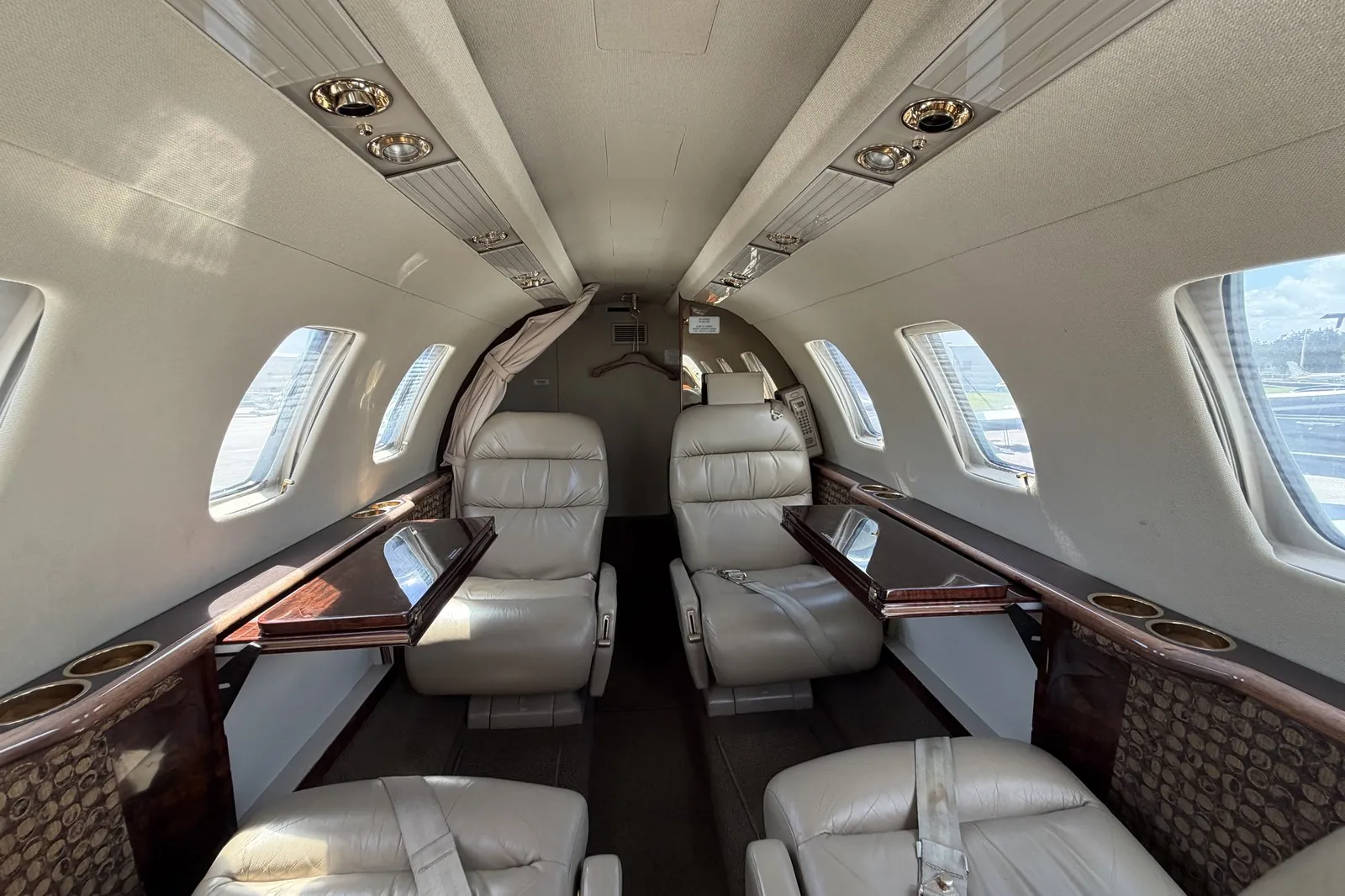 Inside the CJ1 cabin — four-seat leather club with fold-out tables