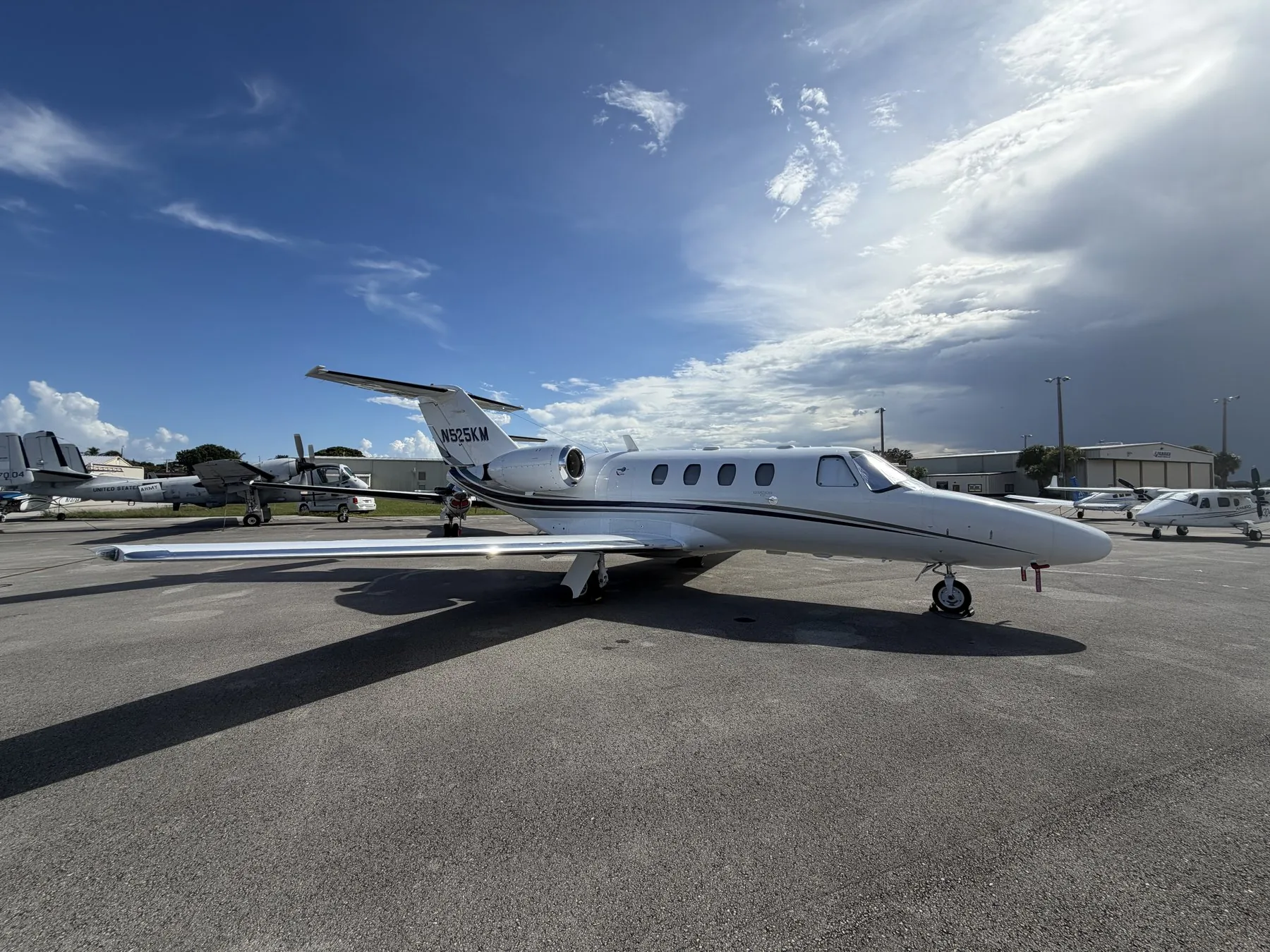 Citation CJ1 N525KM on the ramp under a dramatic South Florida sky